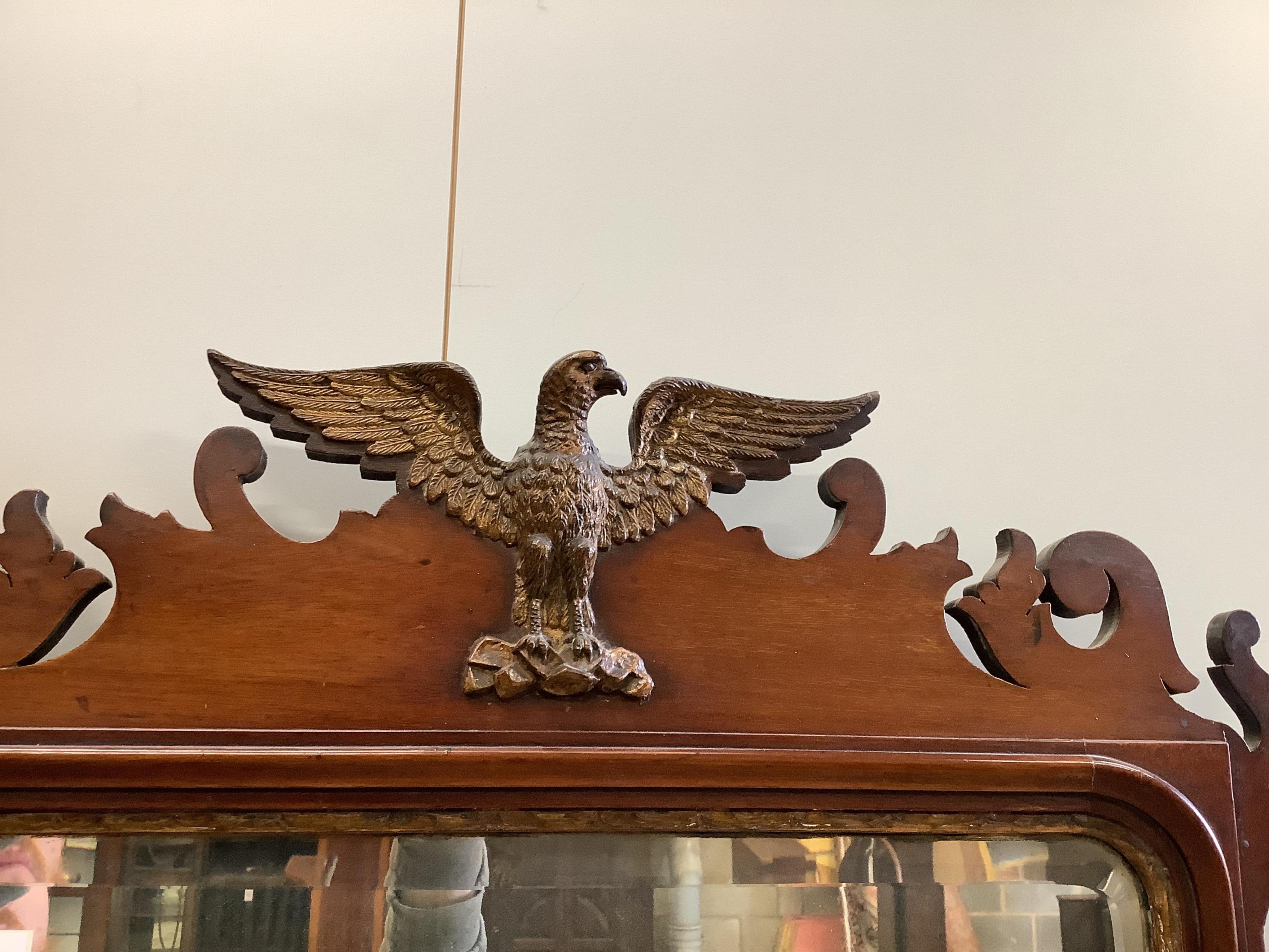 A Georgian style mahogany fret frame wall mirror with eagle crest, width 68cm, height 110cm. Condition - good